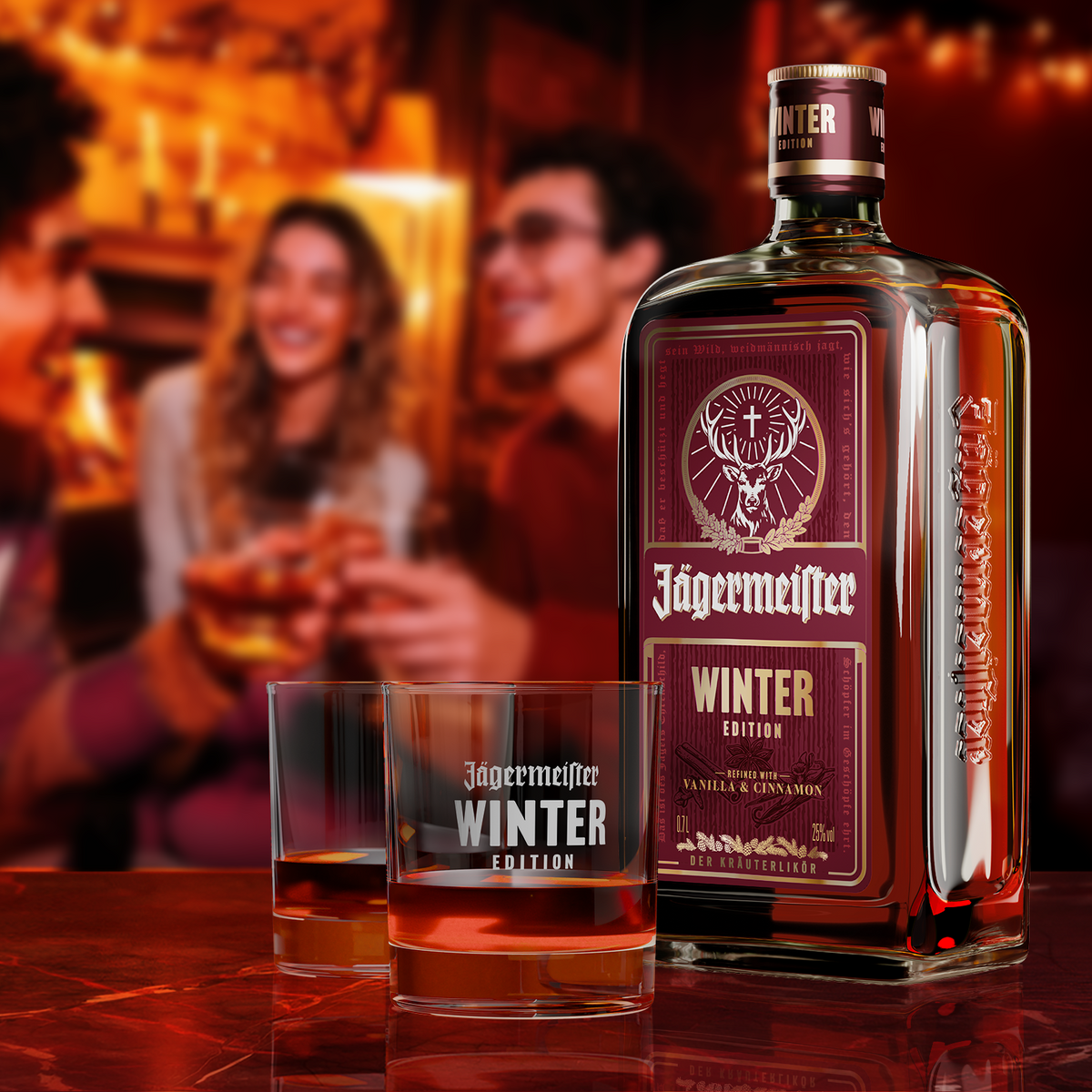 A bottle of Jägermeister Winter Edition  and two matching engraved glasses on a reflective dark table, with a blurred warm bar scene and people in the background.