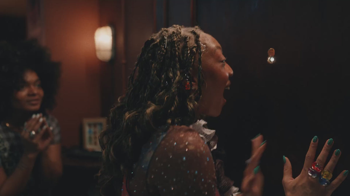A humorous surprise party scene featuring friends hiding a Jägermeister Orange bottle before a guest arrives. As the person enters the room, a series of unexpected events unfolds, leading to the person crashing through a wall into a bathroom. The video ends with a playful and surreal reveal of a person dressed as a mermaid relaxing in a bathtub, creating a lighthearted and comedic atmosphere.