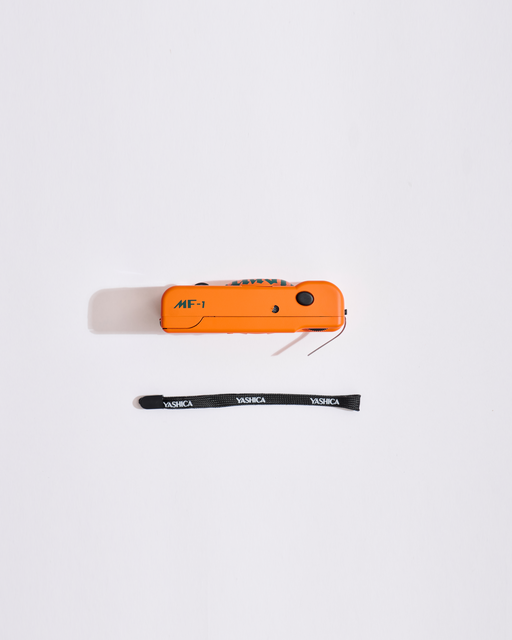 Appareil MF-1 orange avec un tour de cou noir sur fond blanc
