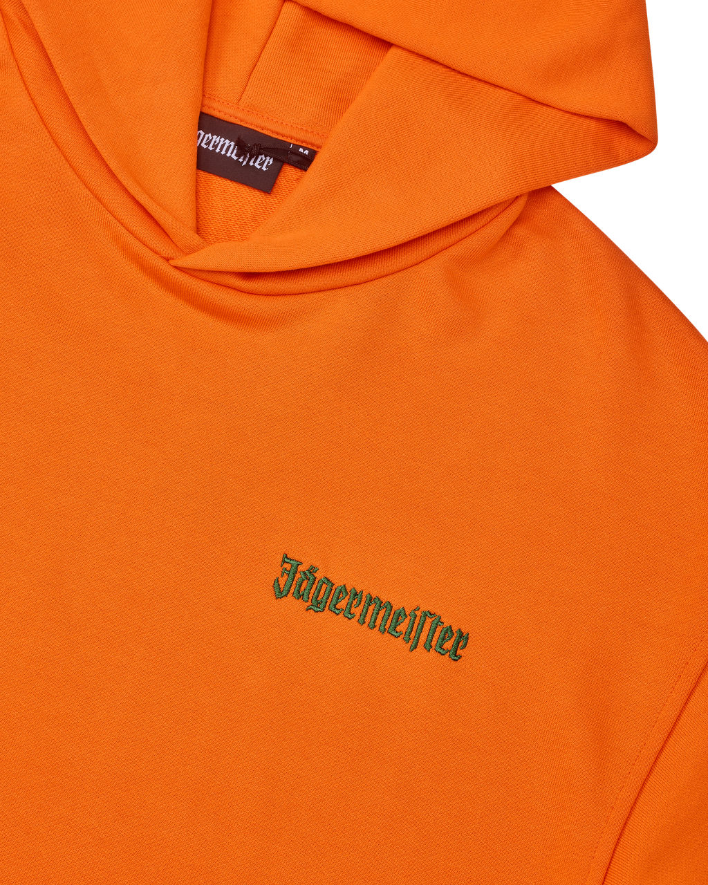 Sweat à capuche orange avec wordmark vert Jägermeister sur la poitrine.