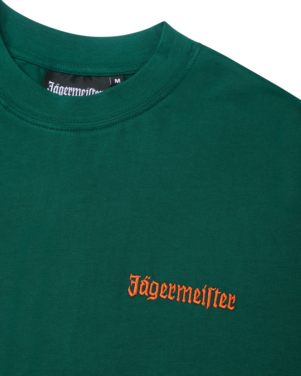 Green t-shirt with an orange Jägermeister wordmark on the chest.